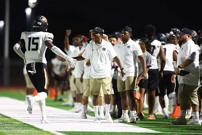 Mark Carter (center, high-fiving) and his brother, Marcus (not pictured), know that a Black coach has never won a state title in Arizona. Their response: “Challenge accepted.”